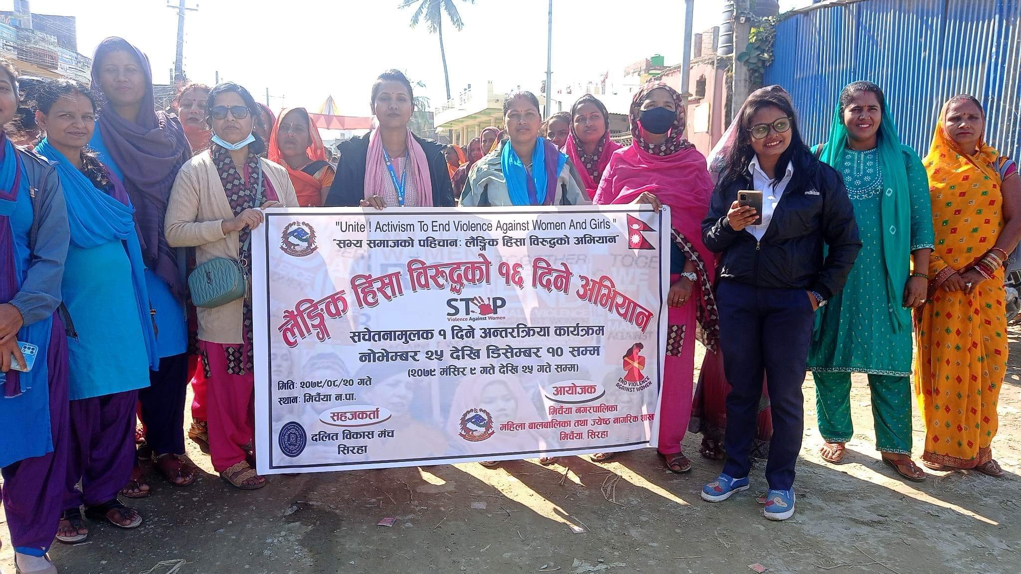 people are holding a banner and posing for a photograph